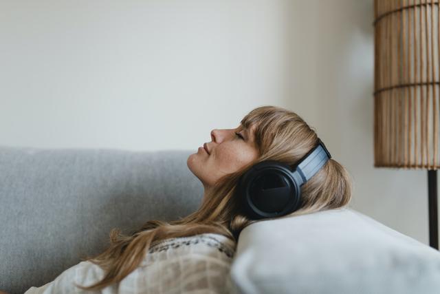 Woman listening to music at home