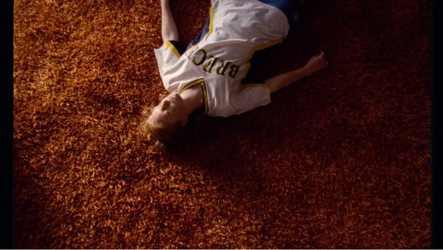 A girl laying on a brown carpet