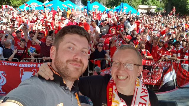 Paul Maych with Chris Pajak taking a picture with a crowd in the background