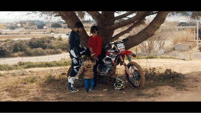 Sebastien standing under a tree near La Cible track with his wife and daughter