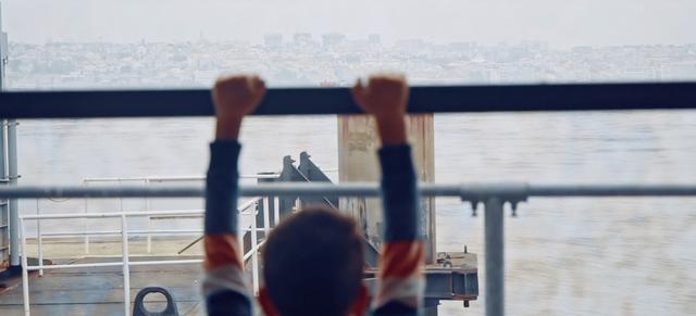 A boy hanging on hand-rail in Lisbon