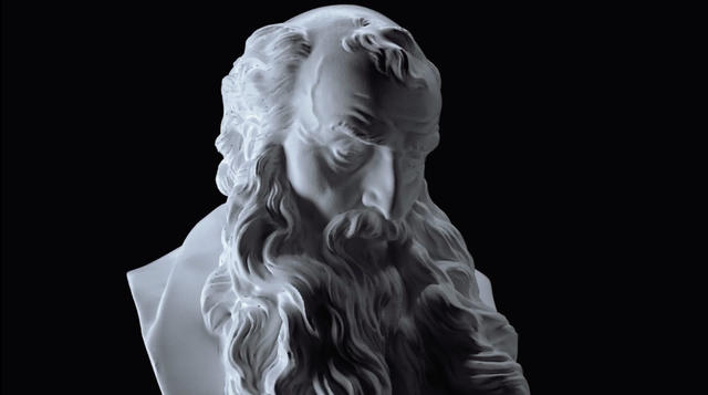 a classical white sculpture on a black background