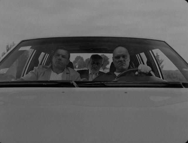 Front look at three men sitting in the car